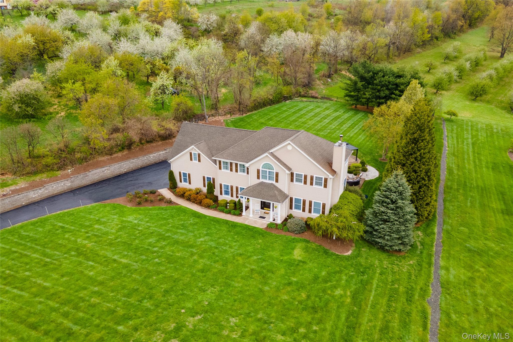60 Idlewild Road Marlboro, NY 12542 - Photo 35 of 37 Expansive property featuring a two-story residence with a gabled roof, a large paved driveway, and meticulously manicured lawns