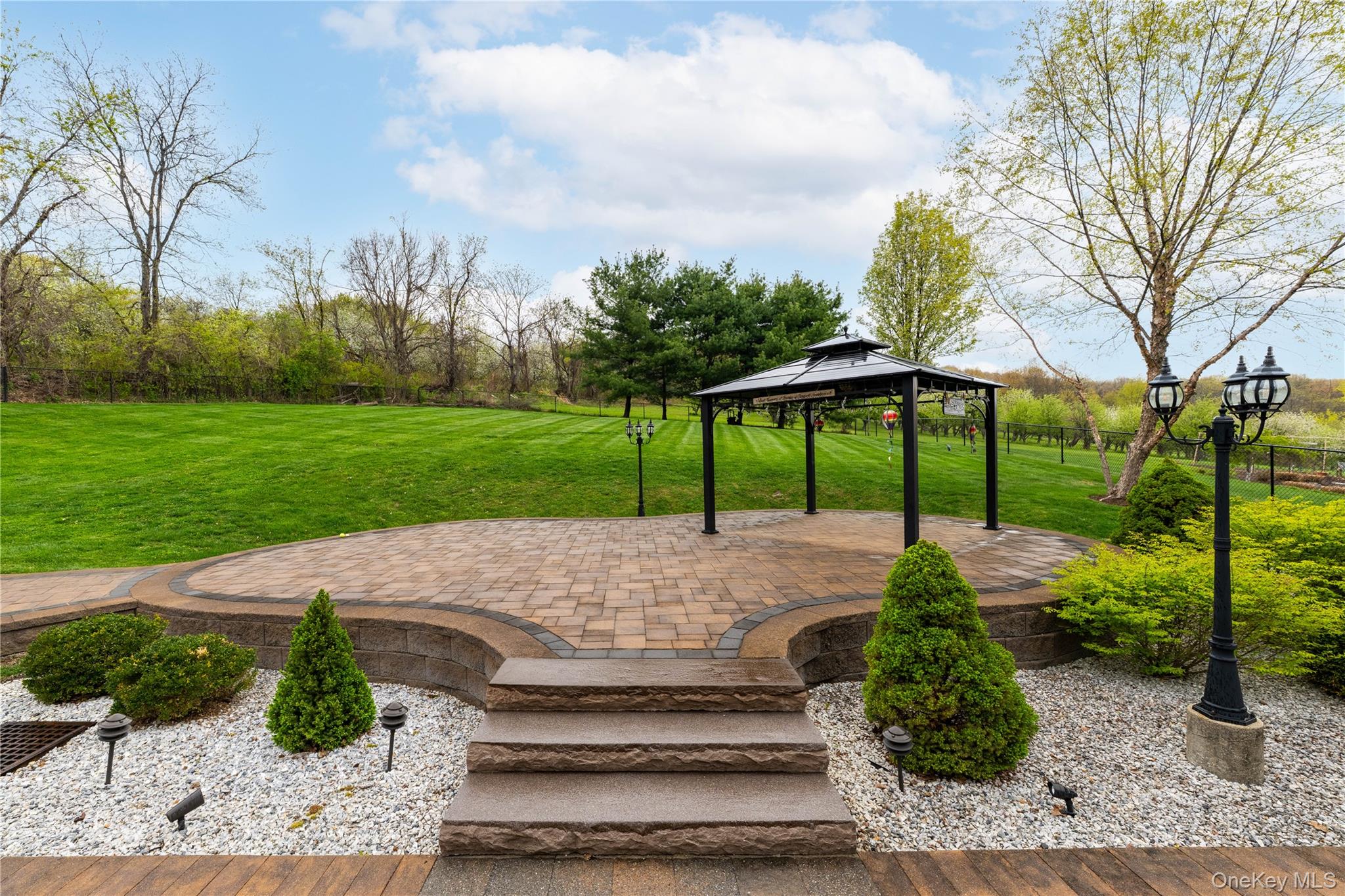 60 Idlewild Road Marlboro, NY 12542 - Photo 6 of 37 Raised paver patio with gazebo surrounded by mature landscaping