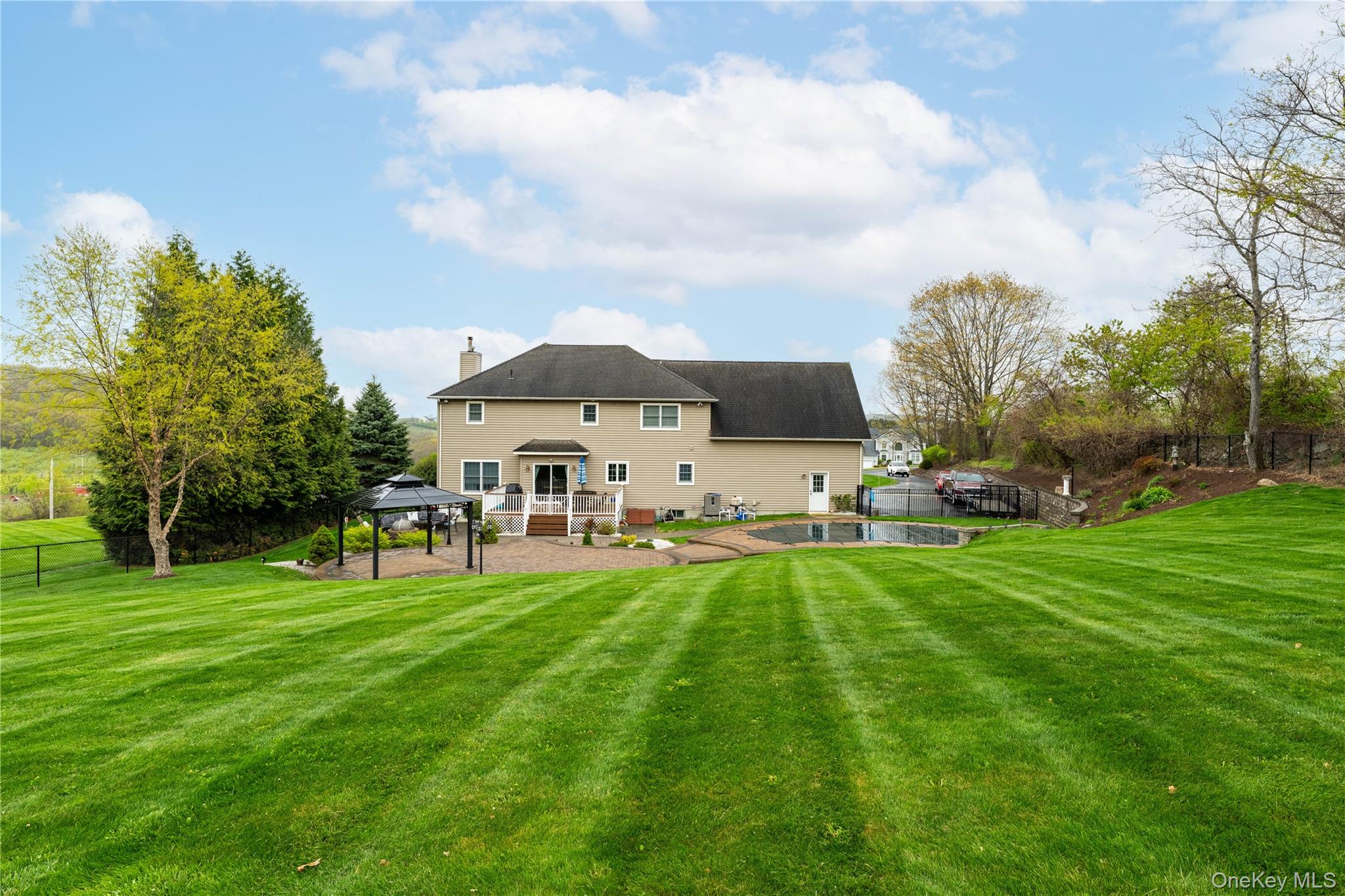 60 Idlewild Road Marlboro, NY 12542 - Photo 7 of 37 Rear facade featuring a patio with a gazebo, an inground pool, and an expansive lawn