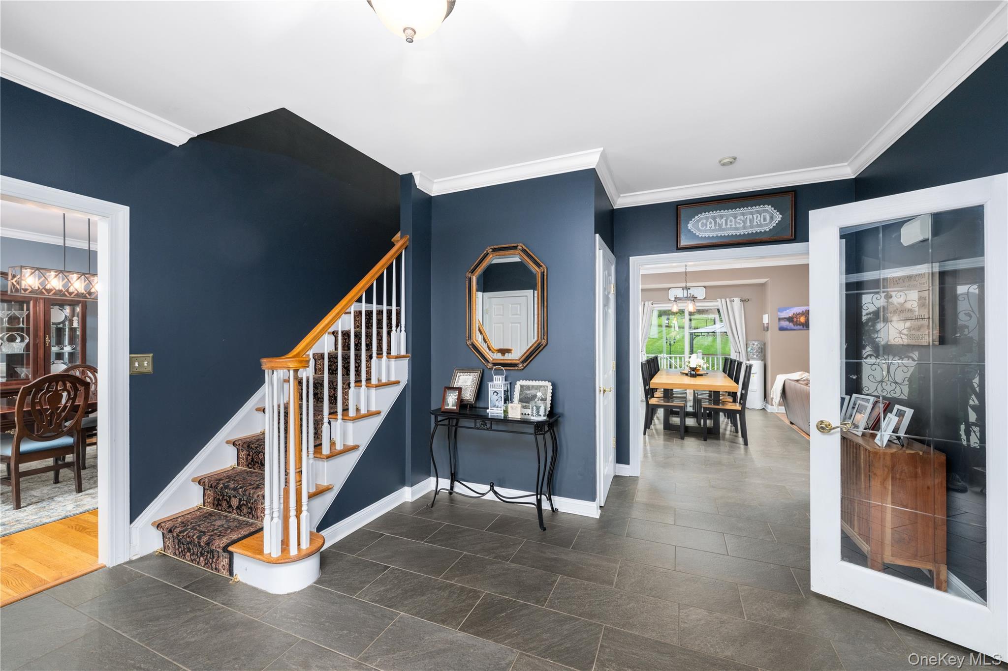 60 Idlewild Road Marlboro, NY 12542 - Photo 8 of 37 Foyer featuring slate-style flooring, a staircase with white risers and wood-finish handrails, deep blue walls, crown molding, and recessed lighting