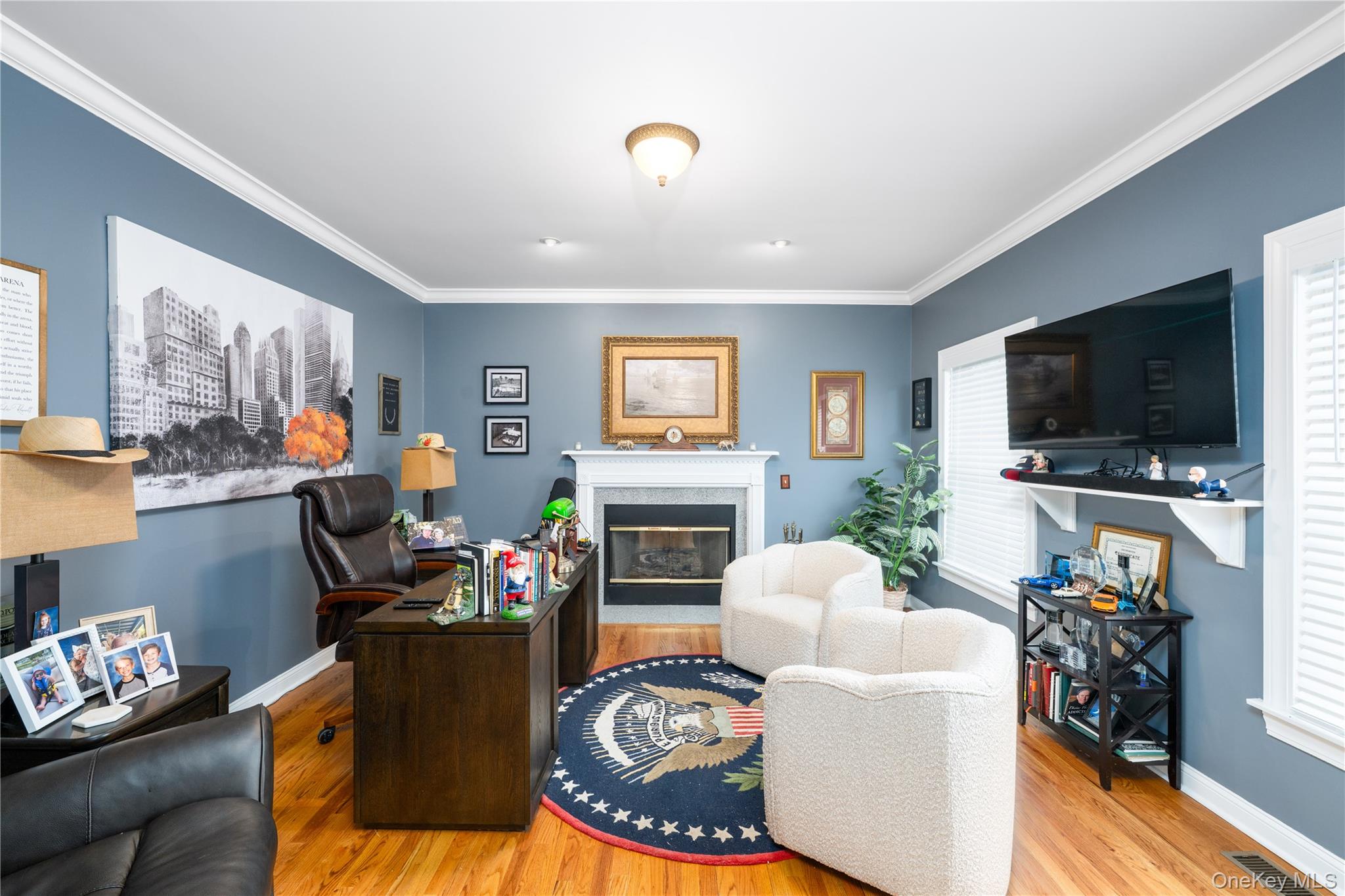 60 Idlewild Road Marlboro, NY 12542 - Photo 9 of 37 Spacious interior room featuring hardwood flooring, a gas fireplace with a white mantel, and crown molding