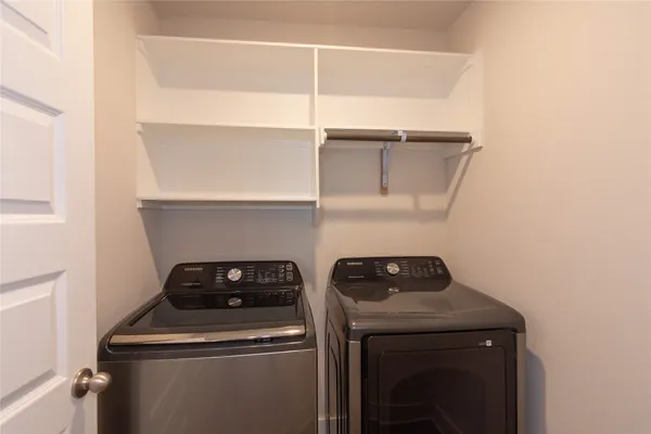 a view of storage and utility room with washer and dryer