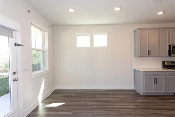 an empty room with a ceiling fan and a window