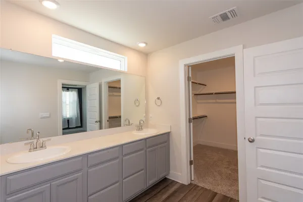 a spacious bathroom with a double vanity sink and a mirror