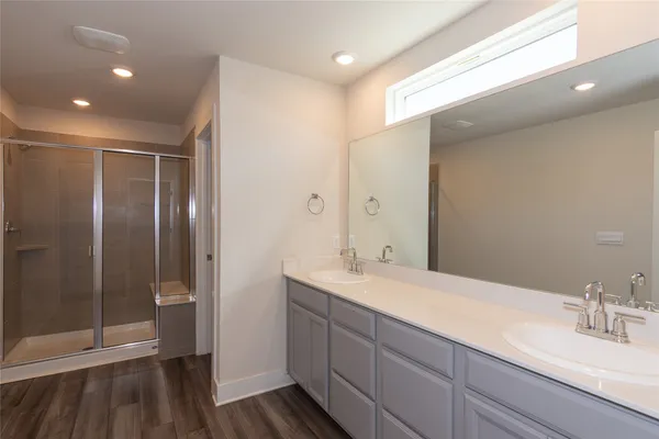 a bathroom with a double vanity sink and mirror