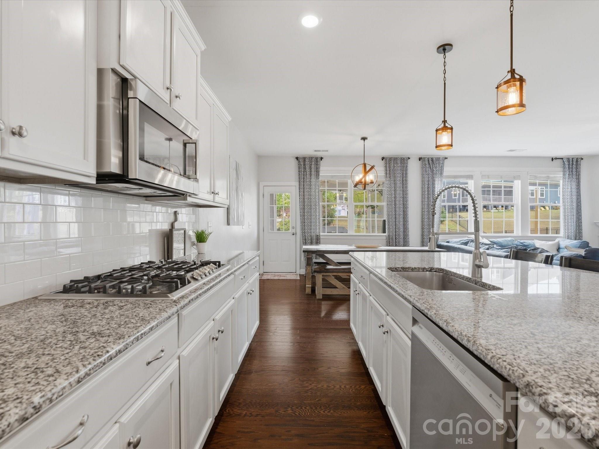 932 Twin Valley Way Fort Mill, SC 29715 - Photo 12 of 48 a kitchen with stainless steel appliances granite countertop a sink stove and cabinets