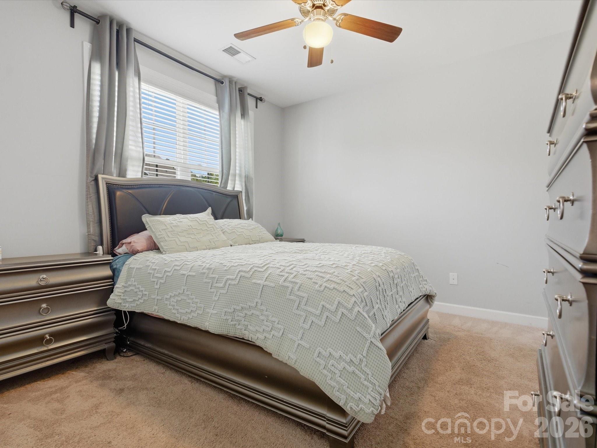 932 Twin Valley Way Fort Mill, SC 29715 - Photo 18 of 48 a bed sitting in a room next to a window