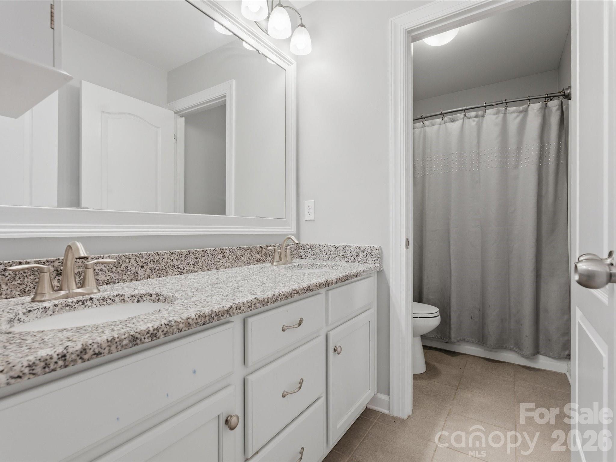932 Twin Valley Way Fort Mill, SC 29715 - Photo 30 of 48 a bathroom with a granite countertop sink and a mirror