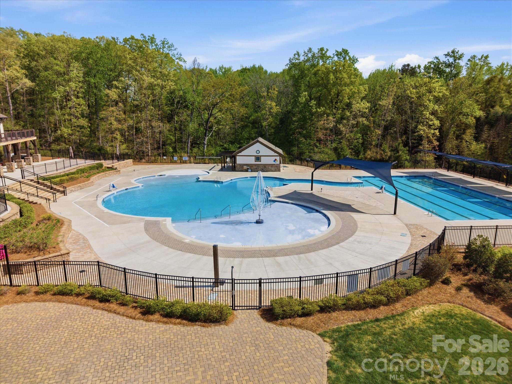 932 Twin Valley Way Fort Mill, SC 29715 - Photo 44 of 48 a swimming pool with some trees in the background