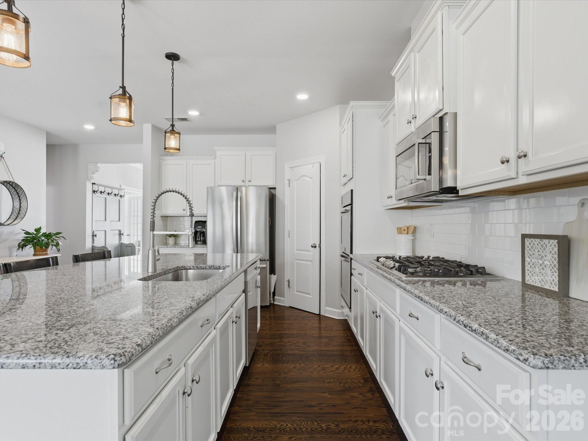 932 Twin Valley Way Fort Mill, SC 29715 - Photo 8 of 48 a kitchen with stainless steel appliances granite countertop a sink stove and cabinets