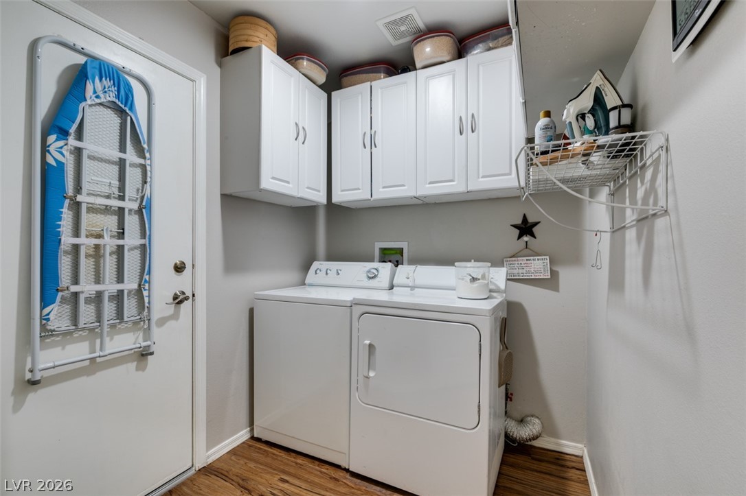 2187 Chapman Ranch Drive Henderson, NV 89012 - Photo 22 of 26 This functional laundry room features convenient storage solutions and modern appliances.