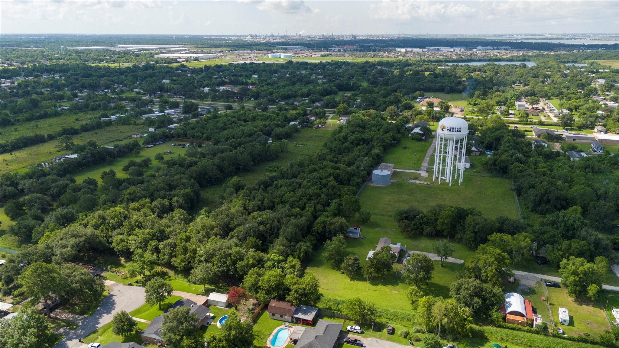 1102 North Battlebell Road Highlands, TX 77562 - Photo 8 of 11 a view of a city with lush green forest