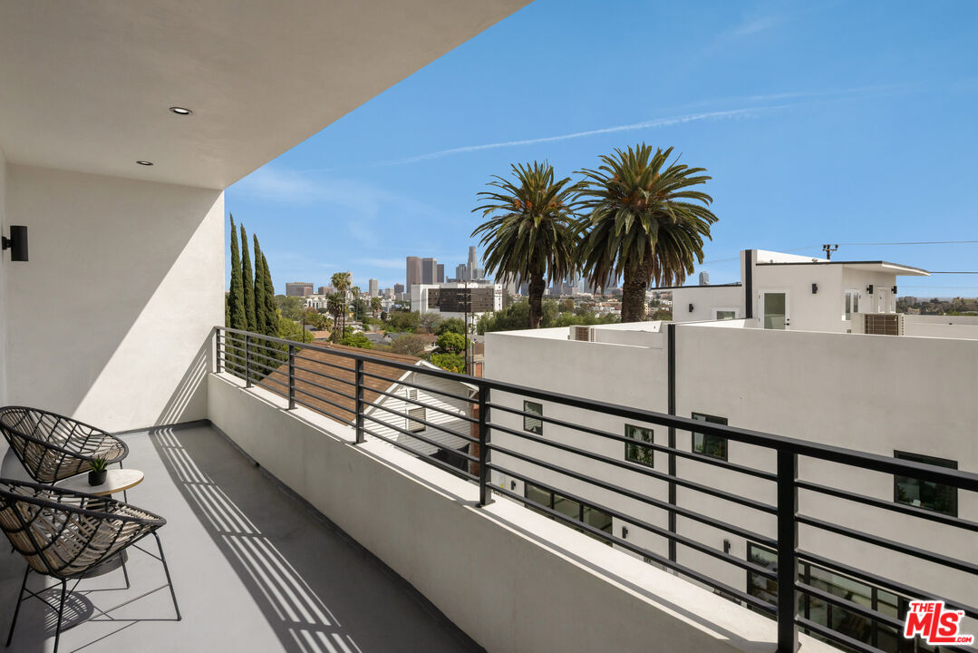 2003 Bellevue Avenue Los Angeles, CA 90026 - Photo 13 of 30 a view of a balcony with chairs and wooden floor