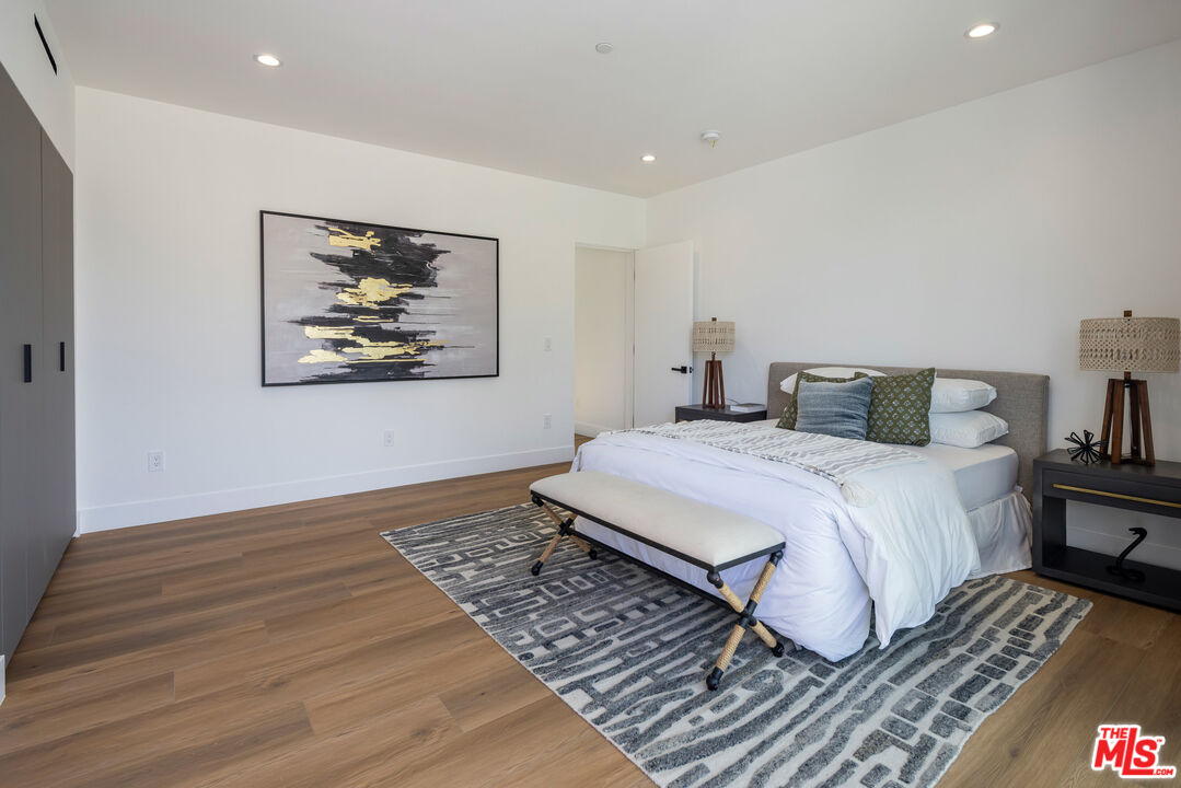 2003 Bellevue Avenue Los Angeles, CA 90026 - Photo 23 of 30 a bedroom with a bed and wooden floor