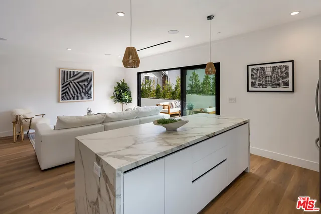 a kitchen with a counter space a large window and furniture