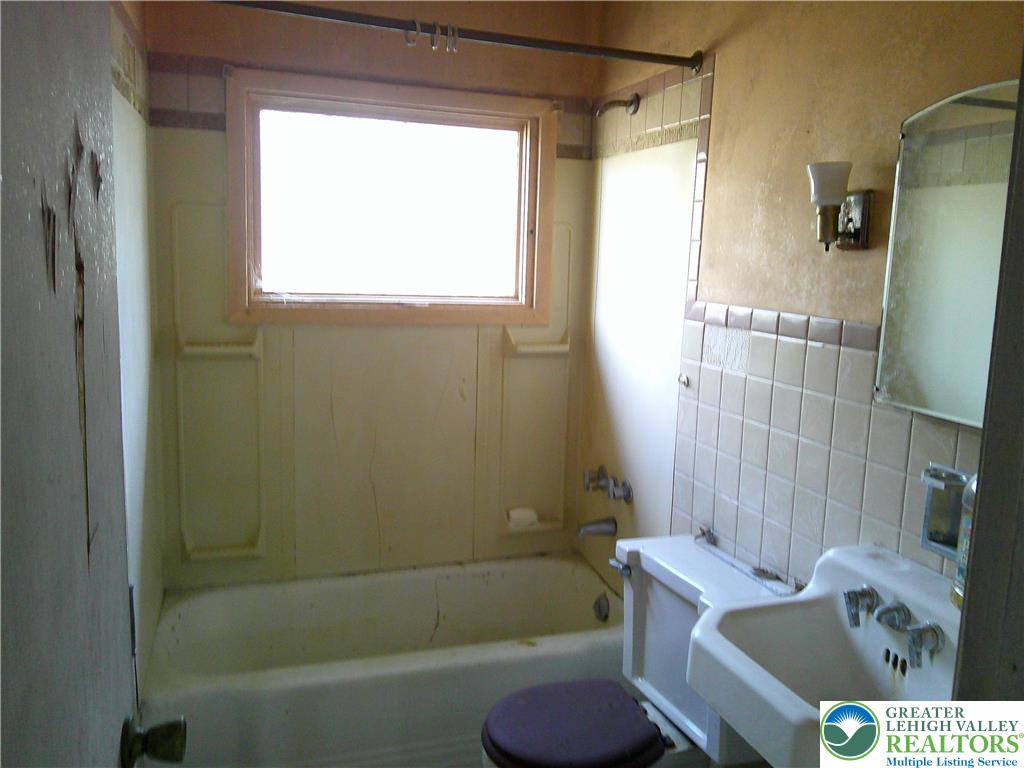 396 Turkey Ridge Road Mount Bethel, PA 18343 - Photo 7 of 9 a bathroom with a sink toilet and shower