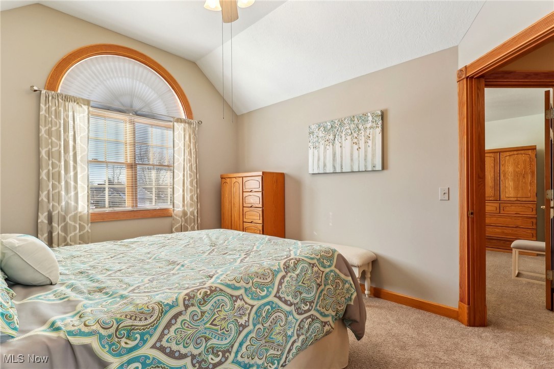 3353 Jens Way Perry, OH 44081 - Photo 32 of 49 Bedroom with ceiling fan, vaulted ceiling, and light carpet