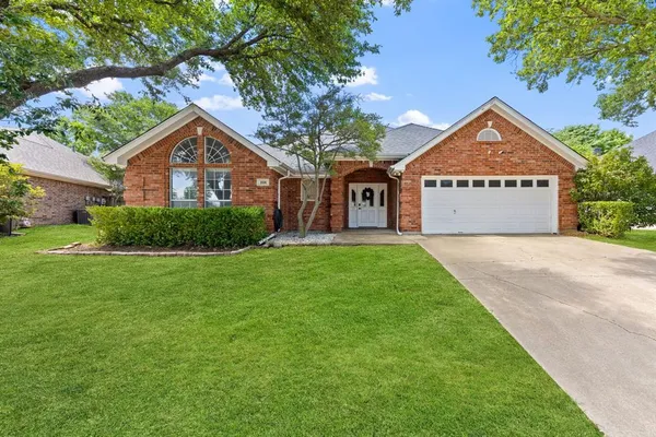 a view of a house with a yard and garage