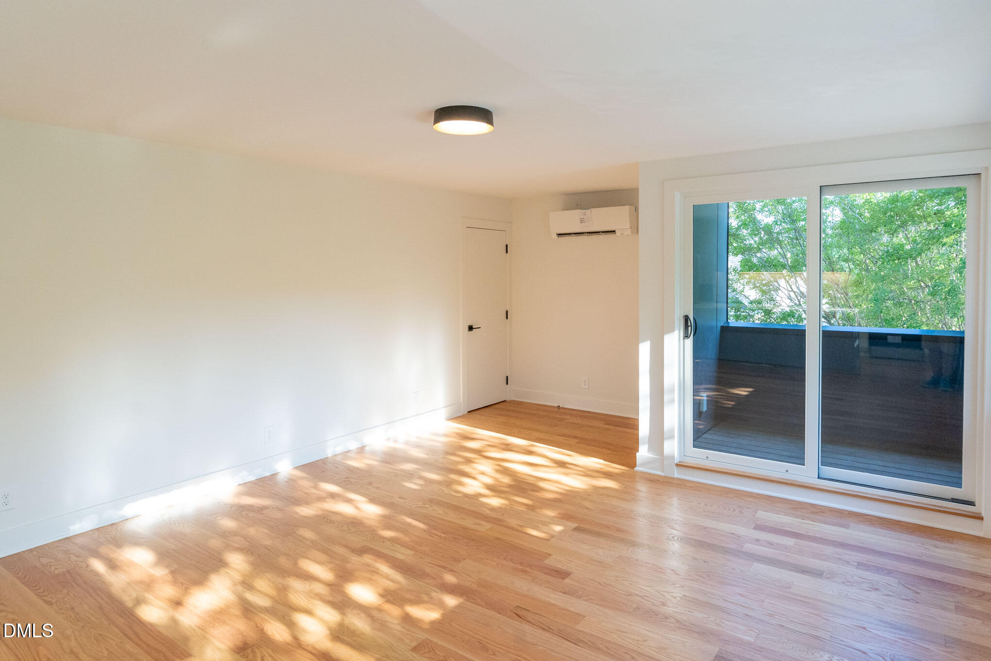 402 East Martin Street Raleigh, NC 27601 - Photo 7 of 23 a view of empty room with wooden floor and fan