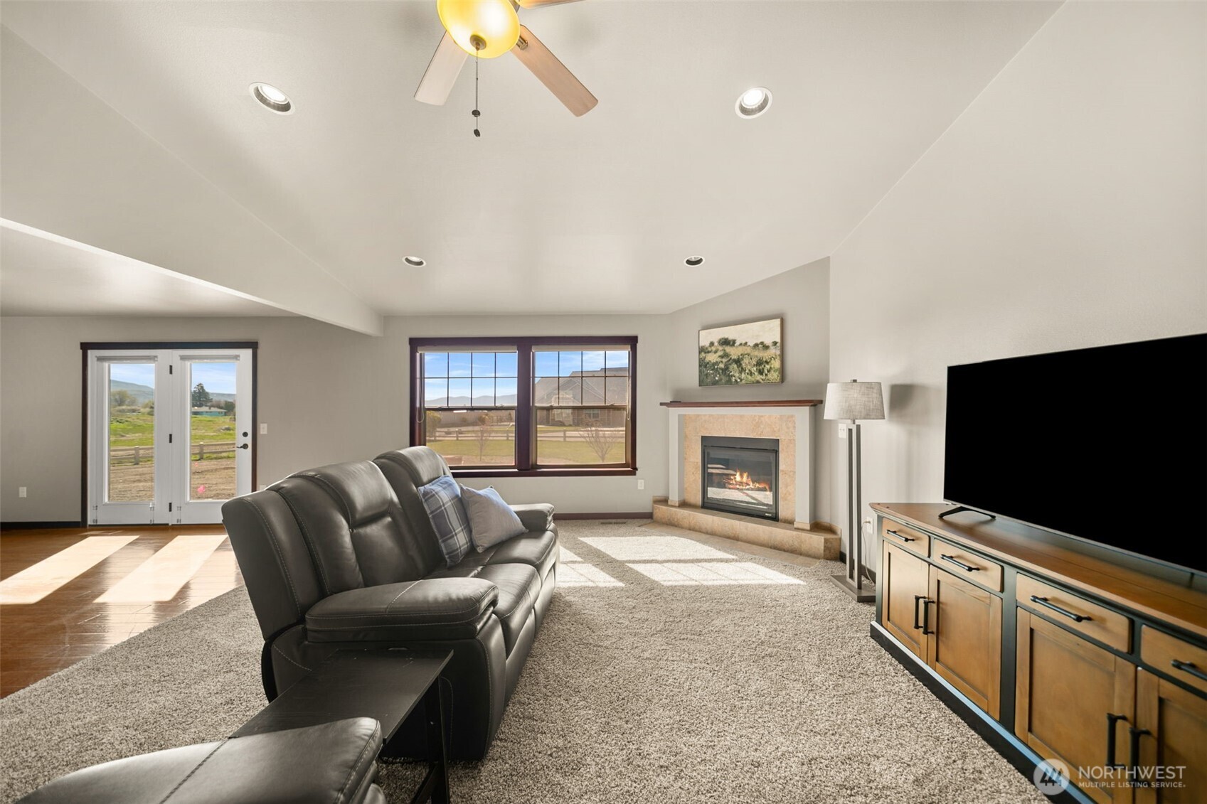 229 Sun Valley Drive Wenatchee, WA 98801 - Photo 6 of 40 a living room with furniture a flat screen tv and a fireplace