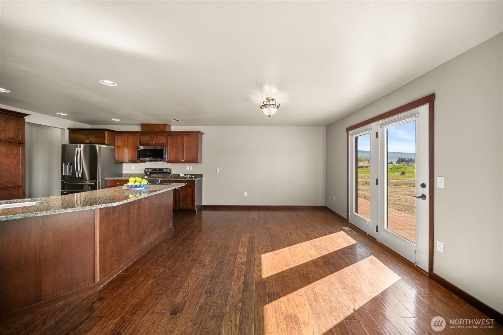 229 Sun Valley Drive Wenatchee, WA 98801 - Photo 9 of 40 a large kitchen with stainless steel appliances kitchen island a large counter top and a wooden floors