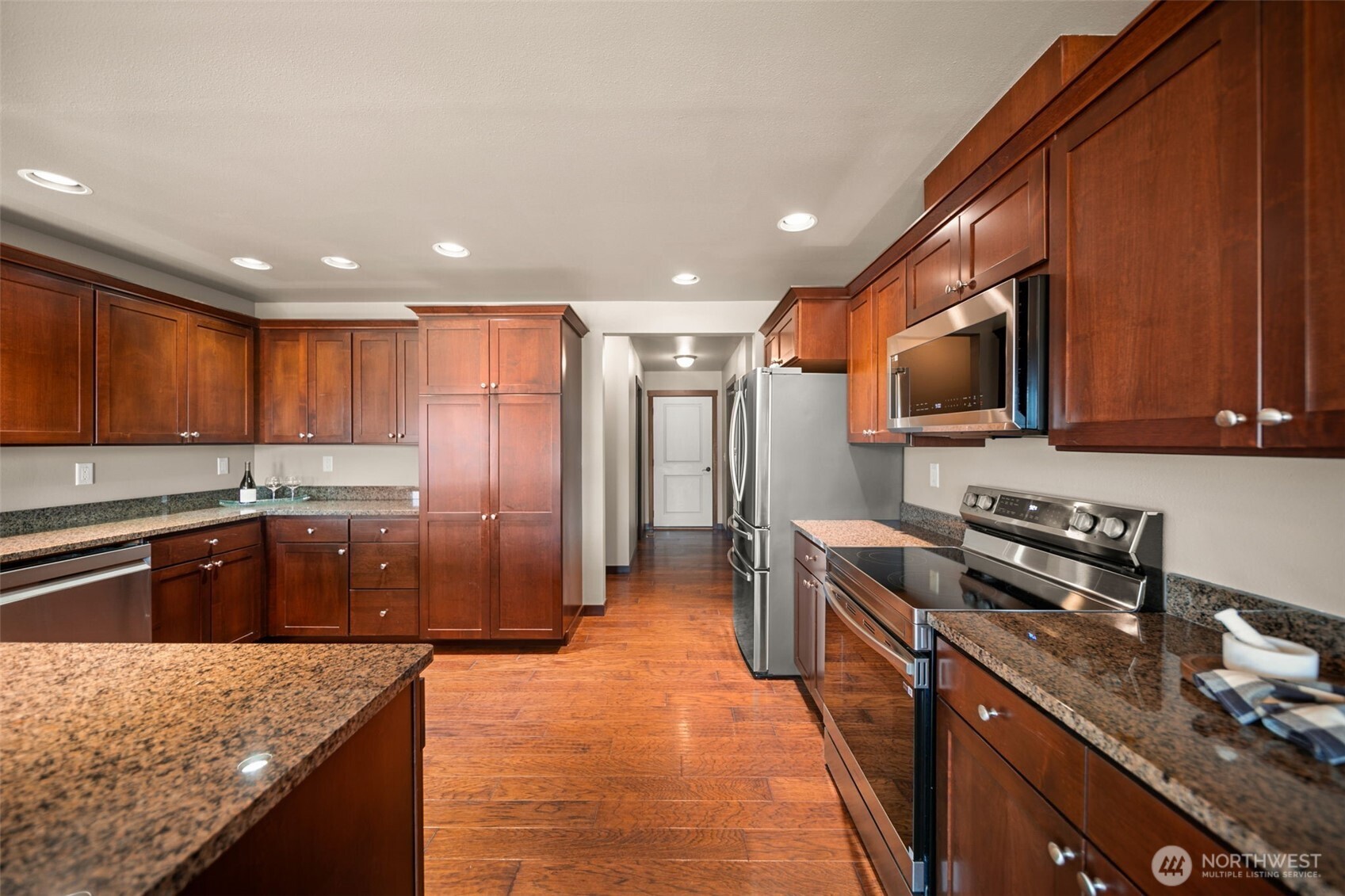 229 Sun Valley Drive Wenatchee, WA 98801 - Photo 10 of 40 a kitchen with stainless steel appliances granite countertop wooden cabinets a refrigerator and a sink