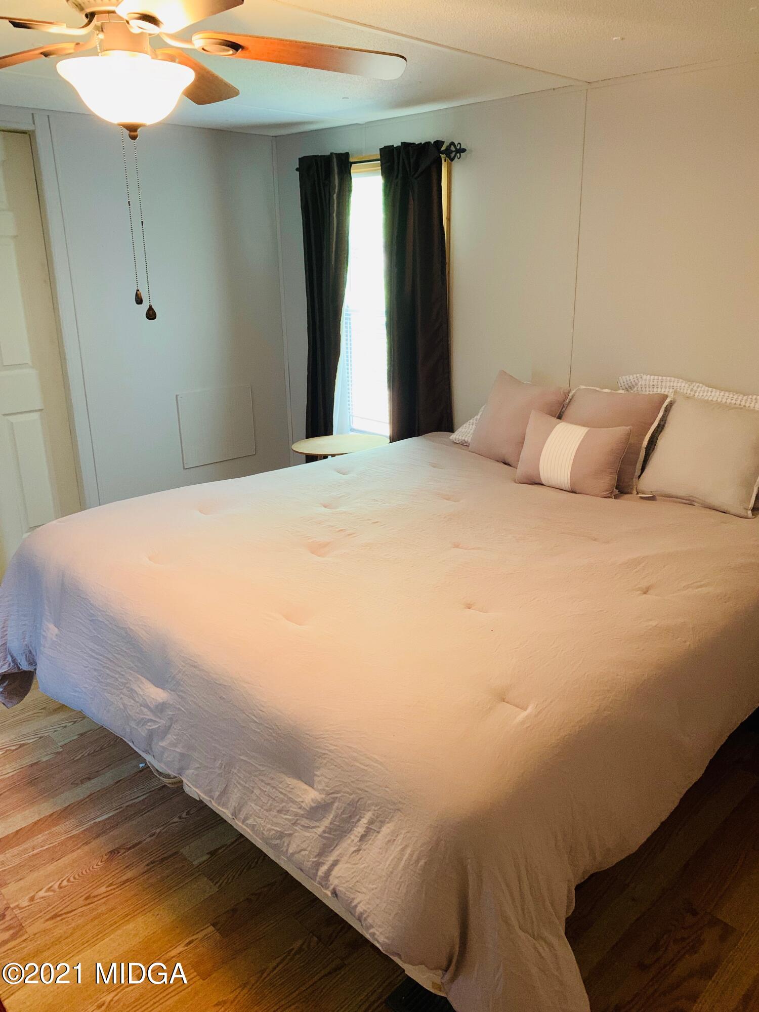 777 Watson Road Forsyth, GA 31029 - Photo 11 of 16 a large bed sitting in a bedroom next to a window