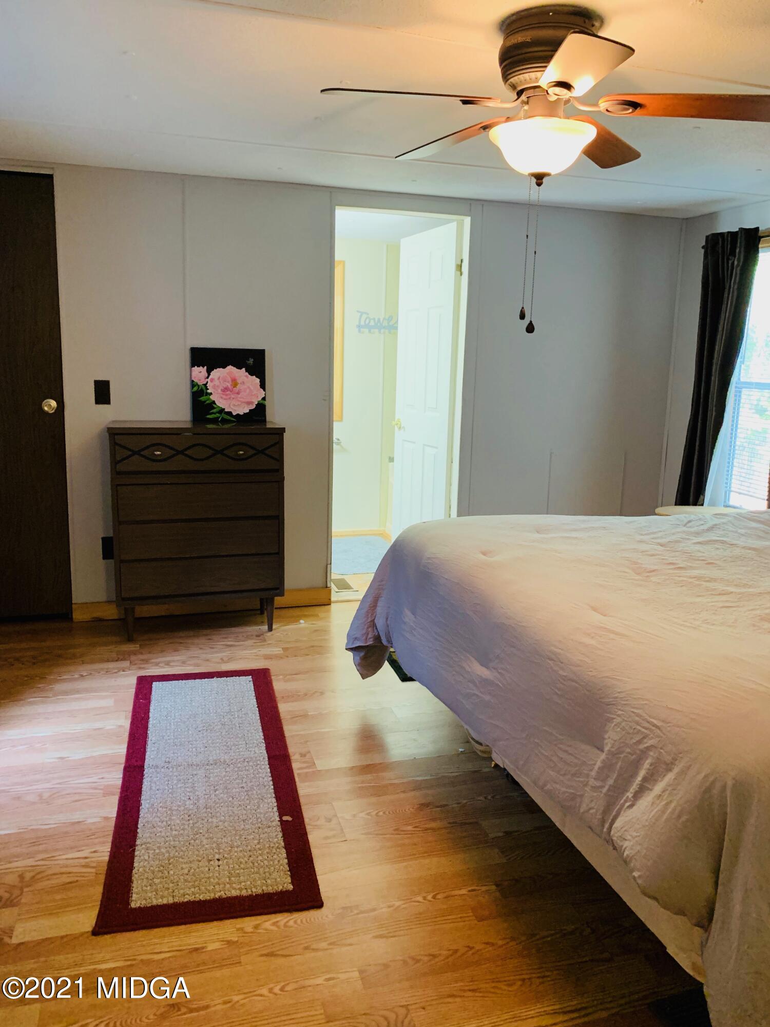 777 Watson Road Forsyth, GA 31029 - Photo 12 of 16 a bedroom with a bed and a window