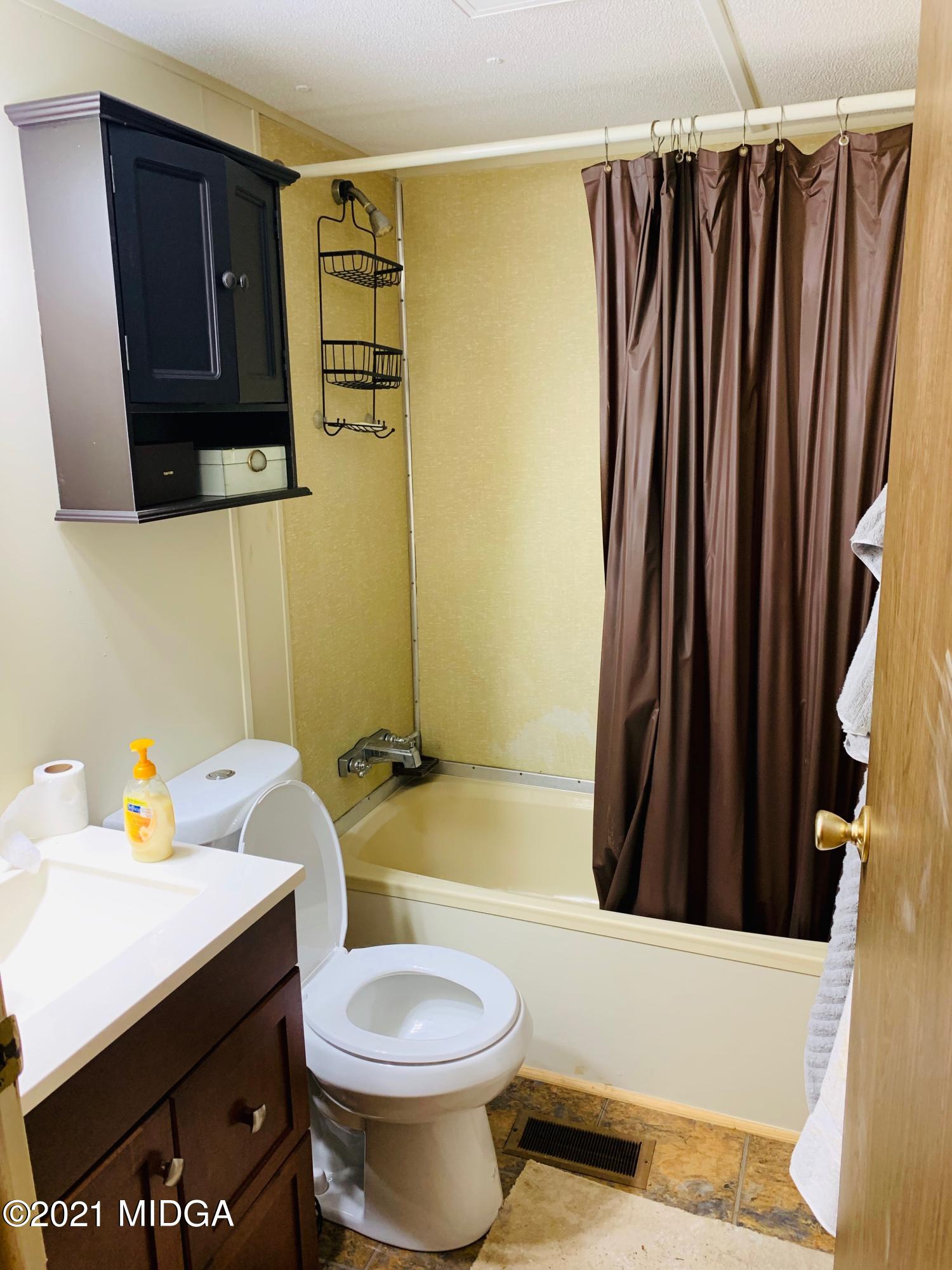 777 Watson Road Forsyth, GA 31029 - Photo 13 of 16 a bathroom with a sink toilet and shower