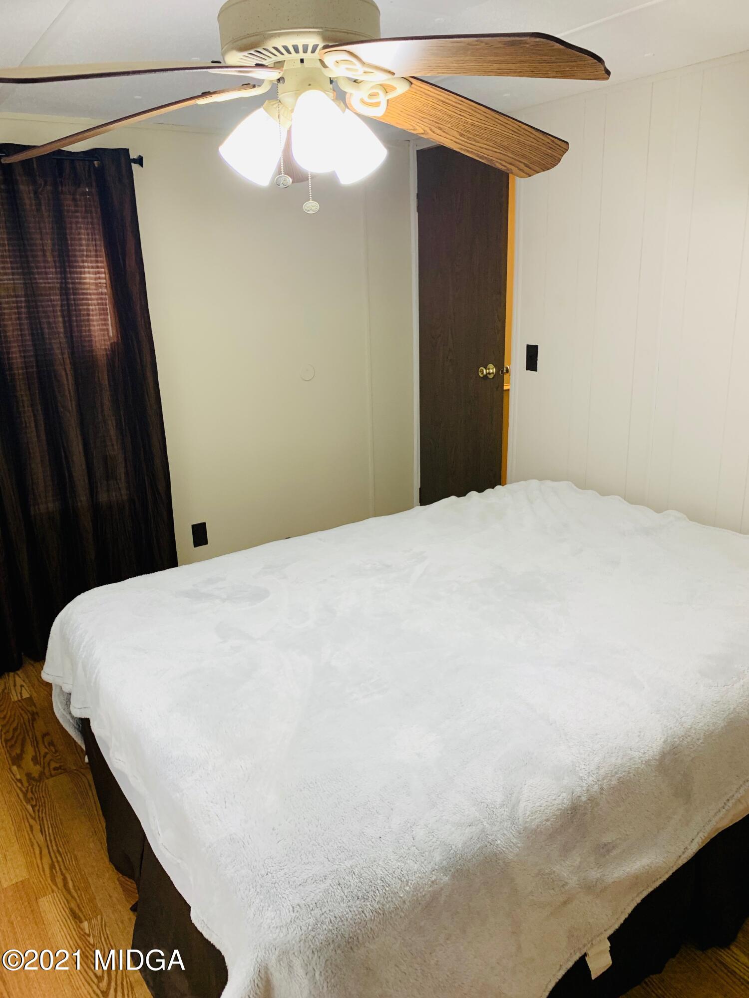 777 Watson Road Forsyth, GA 31029 - Photo 14 of 16 a bed room with a bed and a chandelier