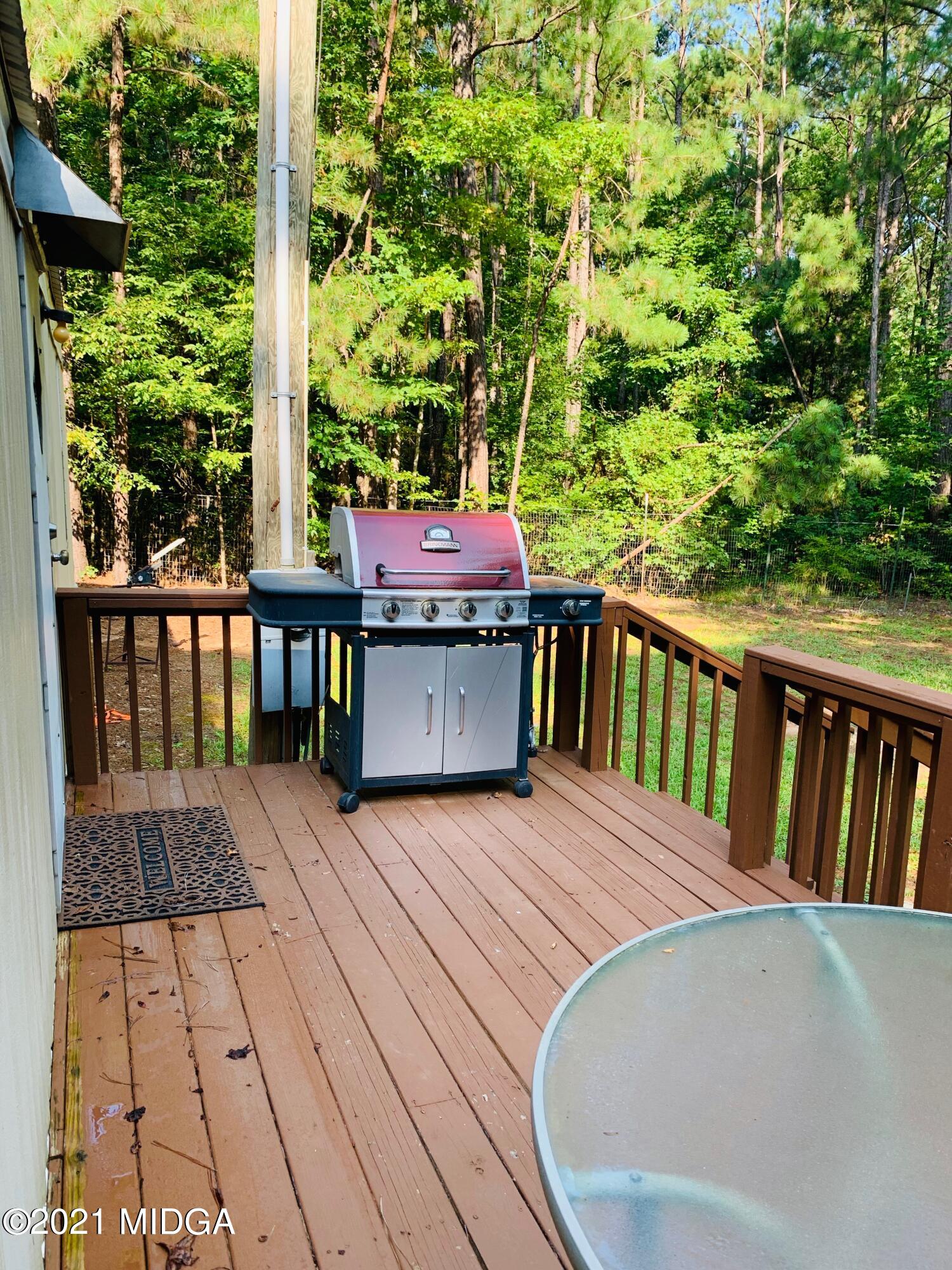 777 Watson Road Forsyth, GA 31029 - Photo 16 of 16 a view of a patio with table and chairs and wooden floor