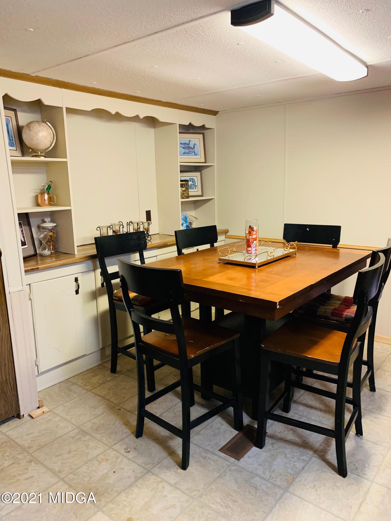 777 Watson Road Forsyth, GA 31029 - Photo 8 of 16 a dining room with a table and chairs