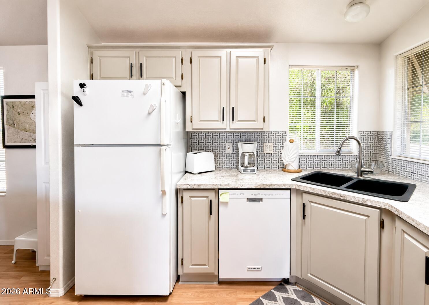 8865 East Baseline Road, Unit 103 Mesa, AZ 85209 - Photo 13 of 47 a white refrigerator freezer sitting inside of a kitchen