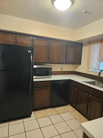 a kitchen with a sink a stove and cabinets