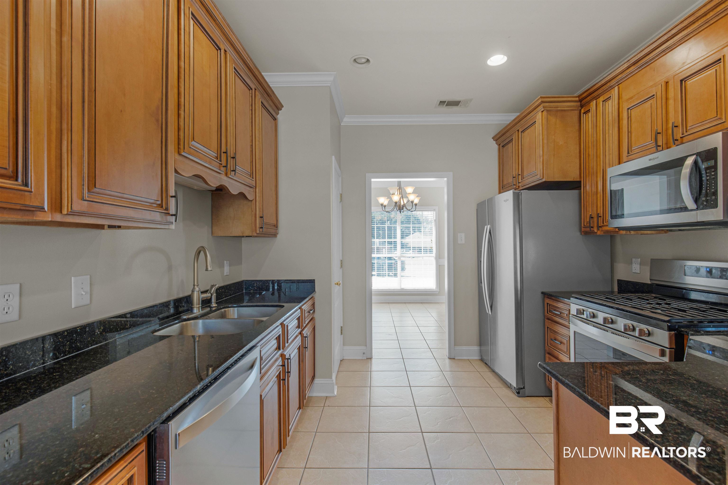 330 Allison Court Mobile, AL 36608 - Photo 9 of 27 Kitchen featuring dark stone countertops, sink, crown molding, and stainless steel appliances