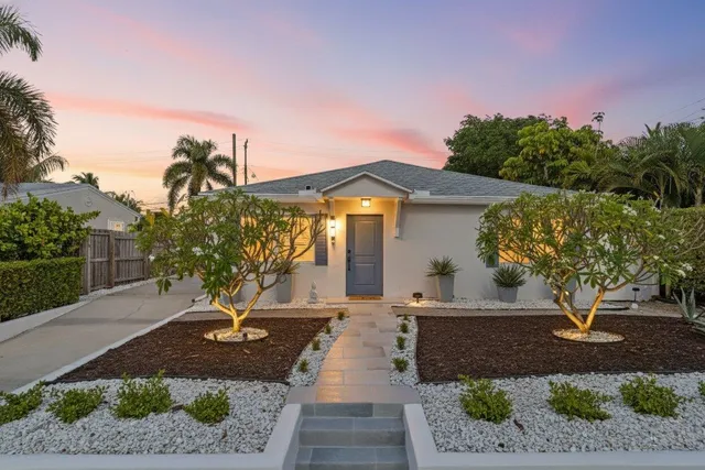 a front view of a house with garden
