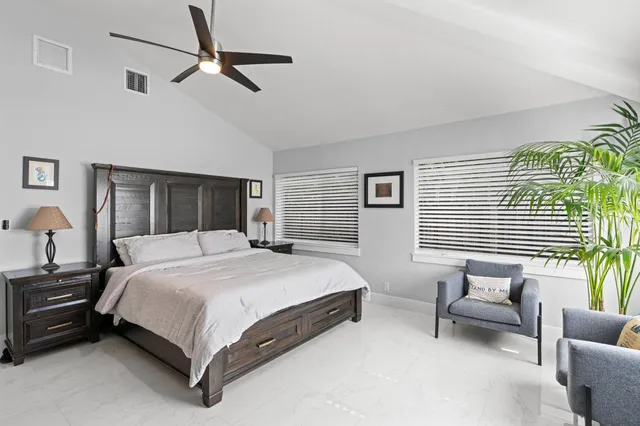 a bedroom with a bed a couch and a window