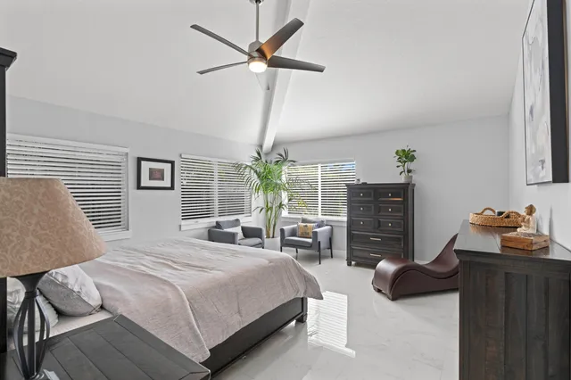 a bedroom with furniture and a window