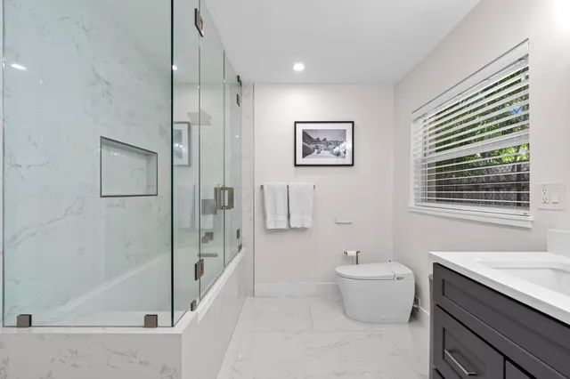 a bathroom with a toilet a sink and bathtub