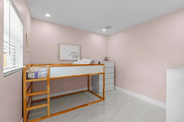 a room that has a table and a dresser in it