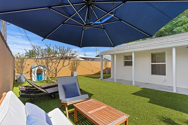 a patio with a yard table and chairs