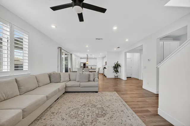 a living room with furniture potted plant and a window