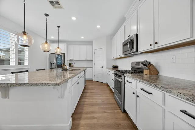 a view of a hallway with wooden floor and closet
