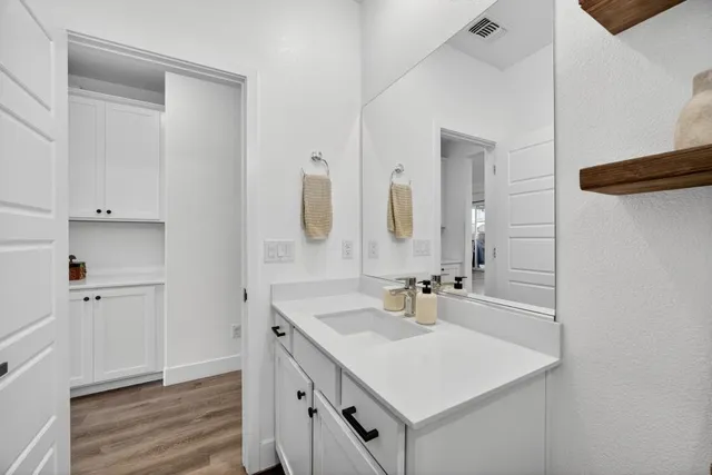 a bedroom with a large bed and a flat tv screen