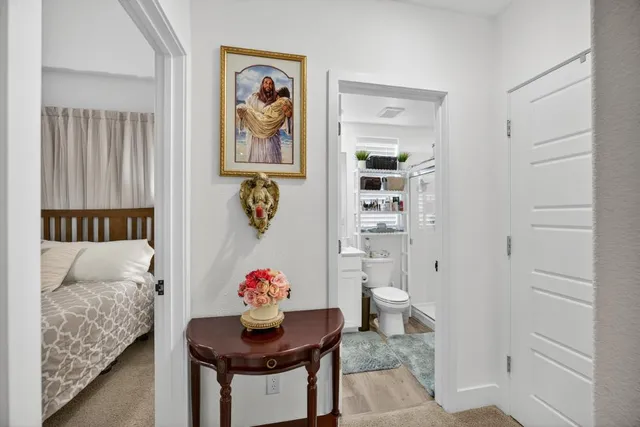 a view of a hallway with workspace and windows