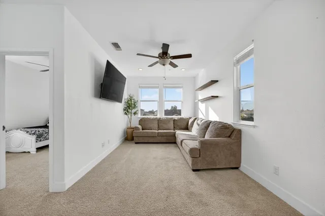 a view of a backyard with table and chairs with wooden fence