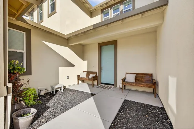 a balcony with furniture and a potted plant