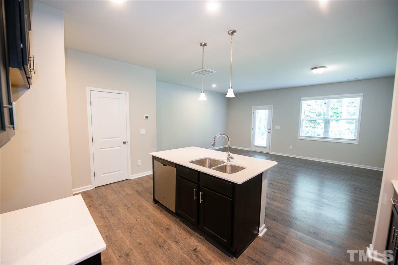 3645 Water Mist Lane, Unit 9 Raleigh, NC 27604 - Photo 5 of 26 a kitchen with a stove a sink a refrigerator and a window