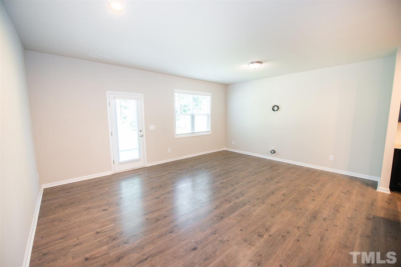 3645 Water Mist Lane, Unit 9 Raleigh, NC 27604 - Photo 8 of 26 an empty room with wooden floor and window