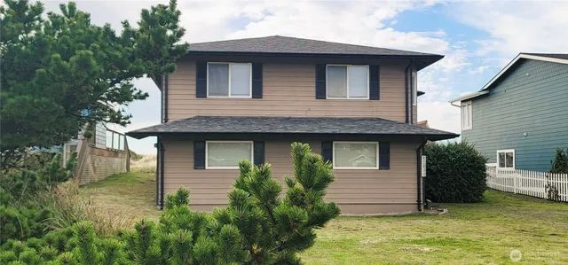 a front view of a house with a yard garage and outdoor seating